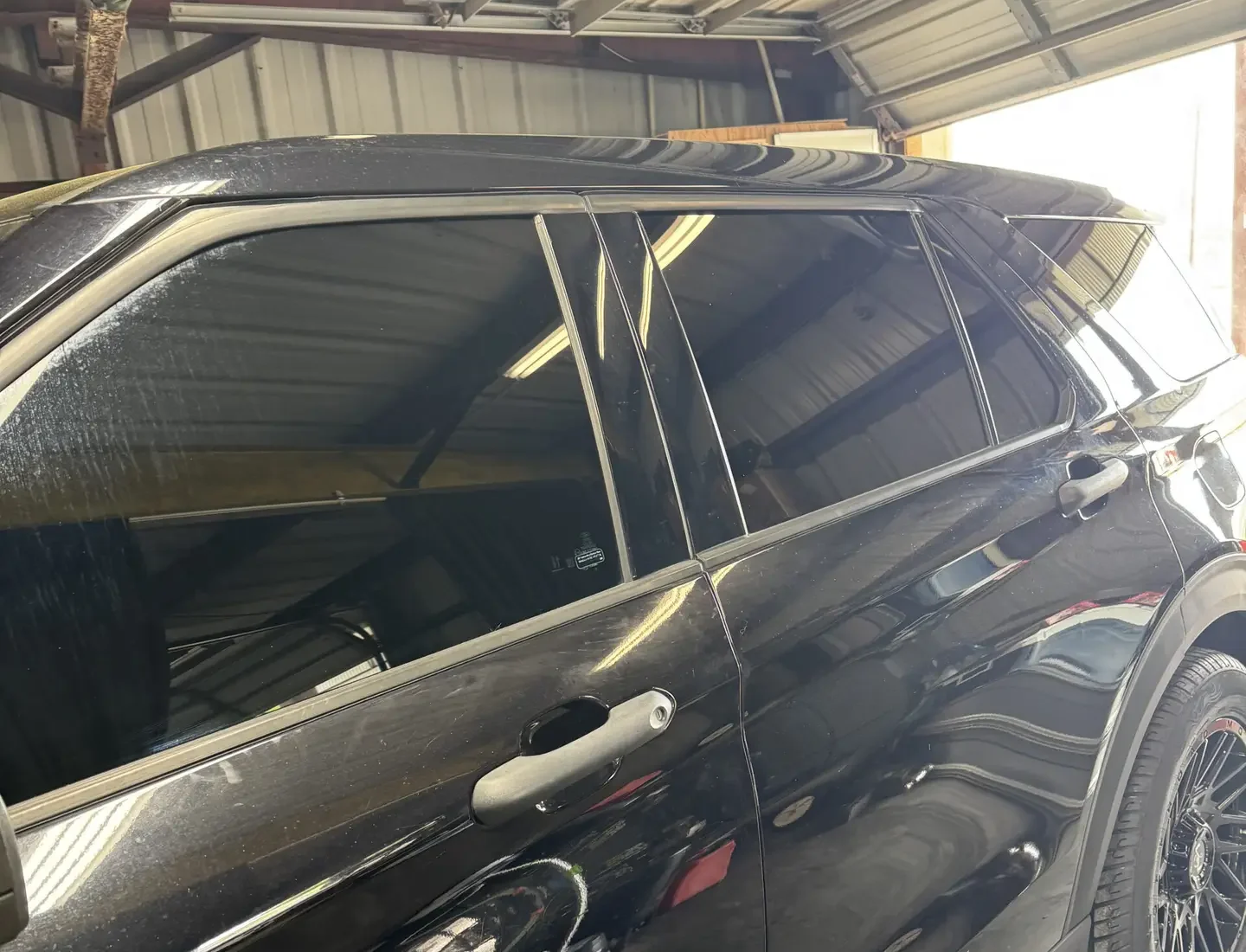 Fresh tint applied to the driver side of a black Ford Explorer